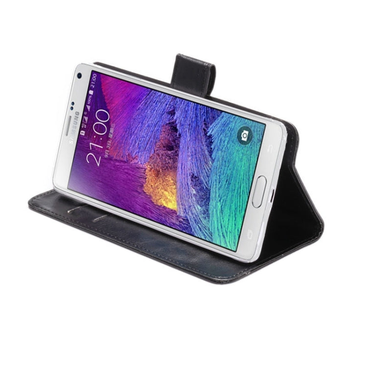 Black faux leather phone wallet case propped open as a viewing stand