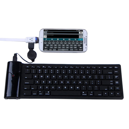 White OTG cable connecting to a tablet via USB and micro USB ports