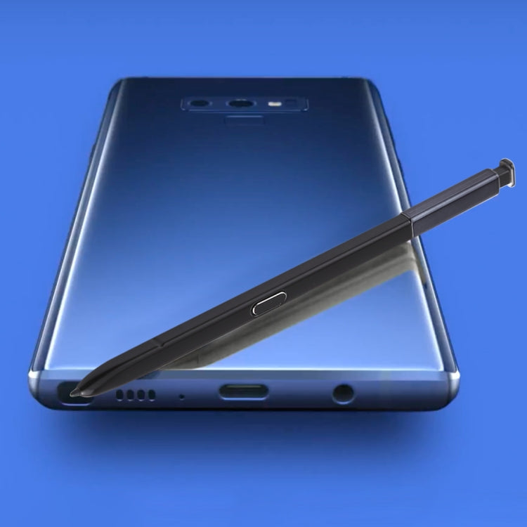 Black stylus pen resting alongside Galaxy Note9 phone