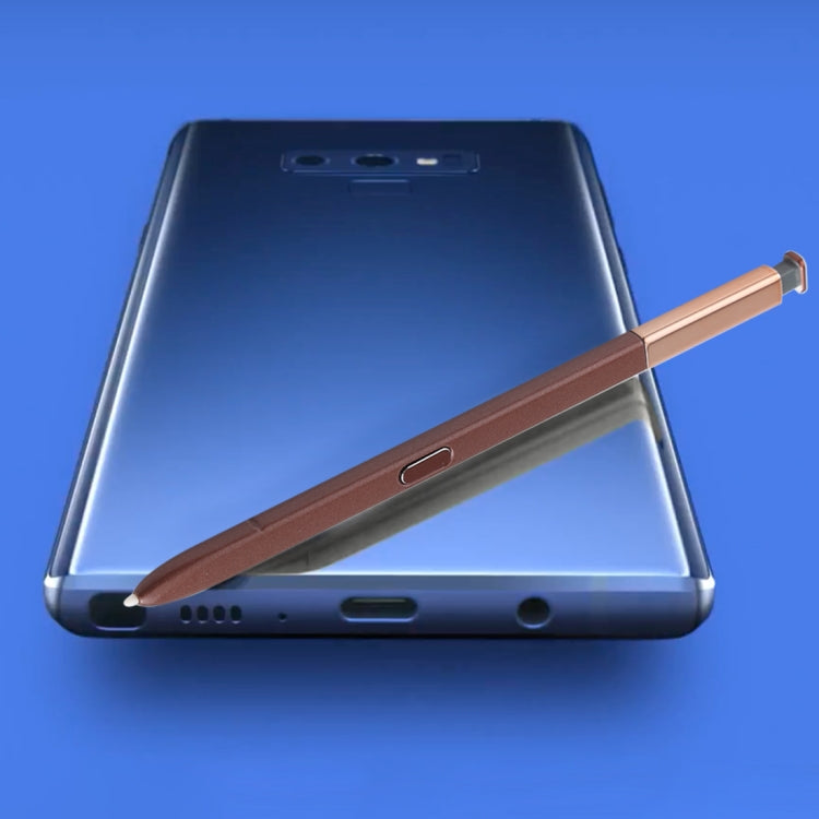 Brown stylus pen resting alongside Galaxy Note9 phone