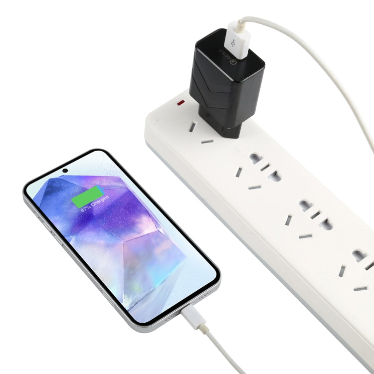 Black EU USB travel charger connected to a power strip and smartphone