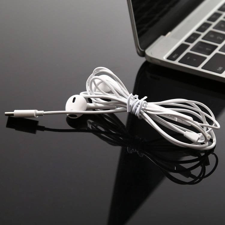 White wired earphones with USB-C connector and neatly coiled cable
