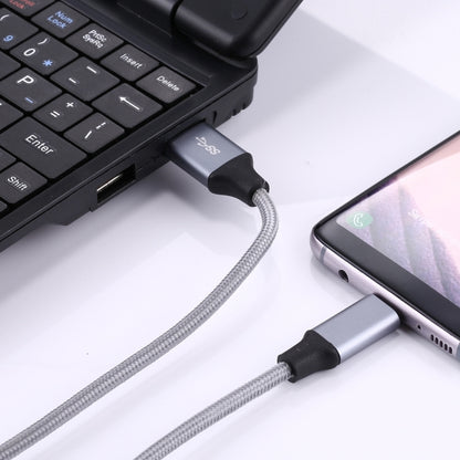 USB-C to USB 3.0 braided cable connected to laptop USB port and a smartphone USB-C port