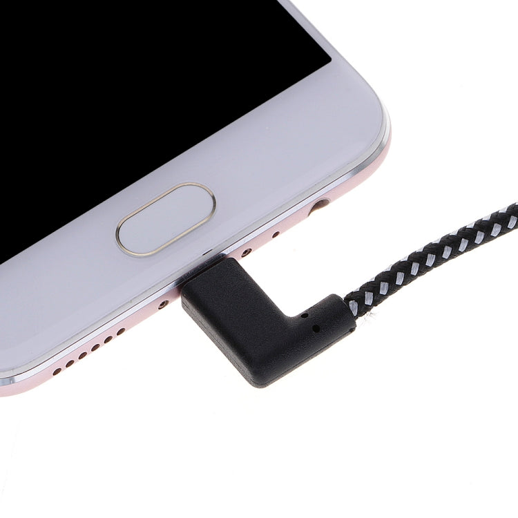 Black right-angle USB-C connector plugged into device charging port