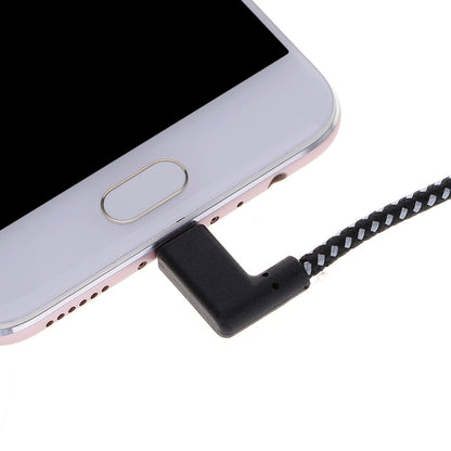Black right-angle USB-C connector plugged into device charging port