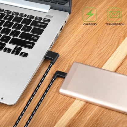 Black braided USB-A to USB-C cable connecting phone to laptop
