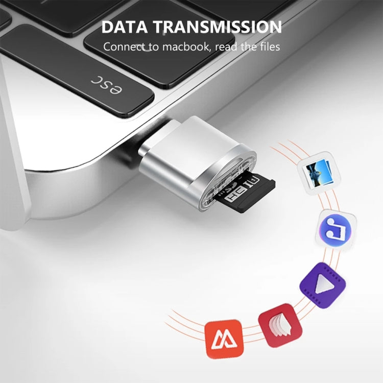 Silver USB-C to TF card reader adapter next to a computer keyboard