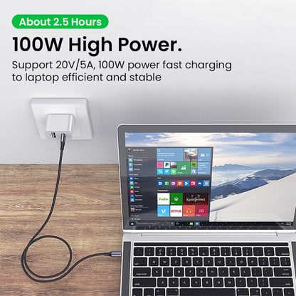 USB-C cable connected to a laptop power port and wall charger adapter.