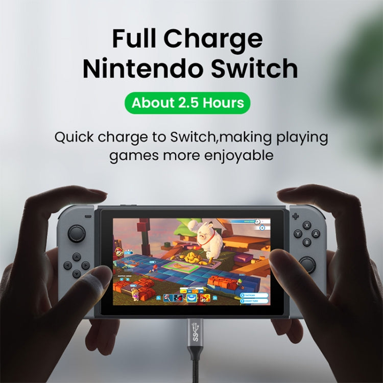 USB-C cable charging a handheld device via its dock connection.
