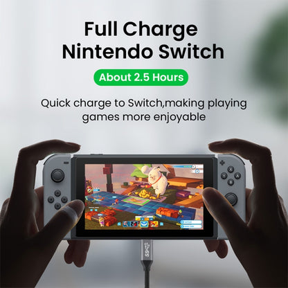 USB-C cable charging a handheld device via its dock connection.