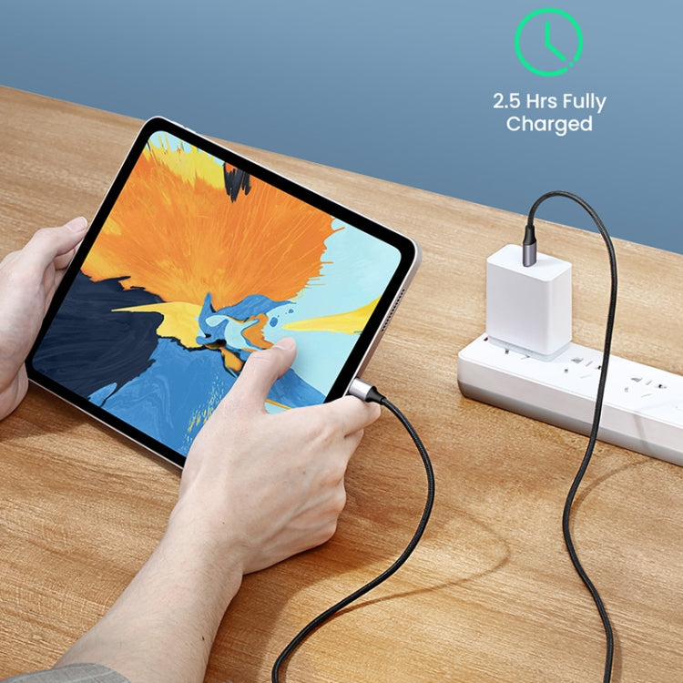 USB-C cable plugged into a tablet and charging adapter on a desk.