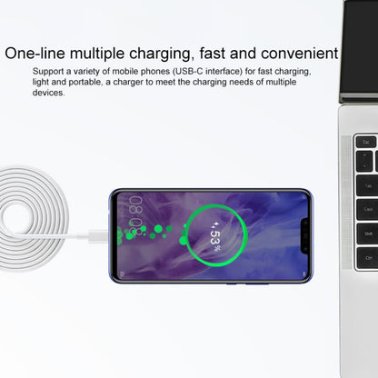 Huawei laptop power adapter with coiled cable connected to a smartphone