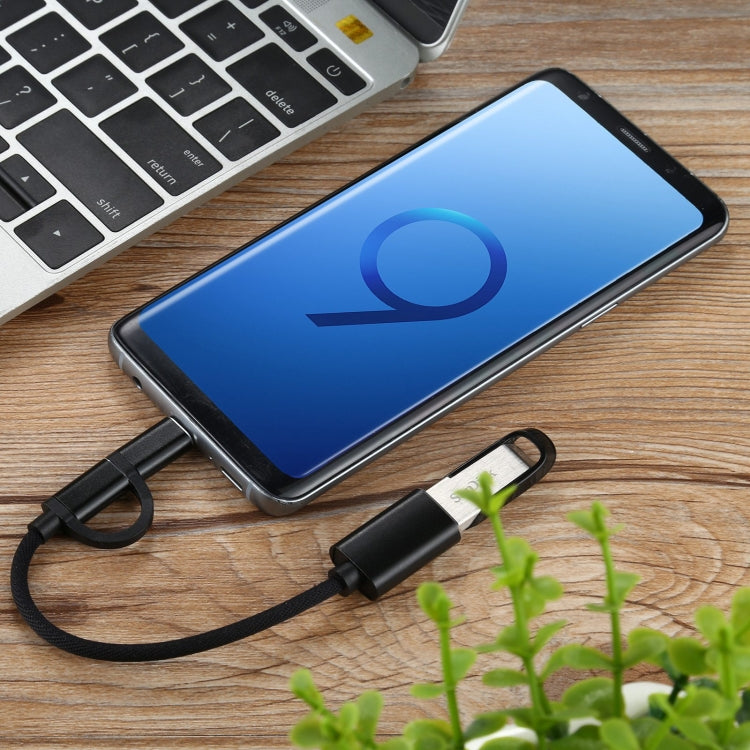 Black USB 3.0 adapter cable connected to a phone, micro USB and USB-C male ends