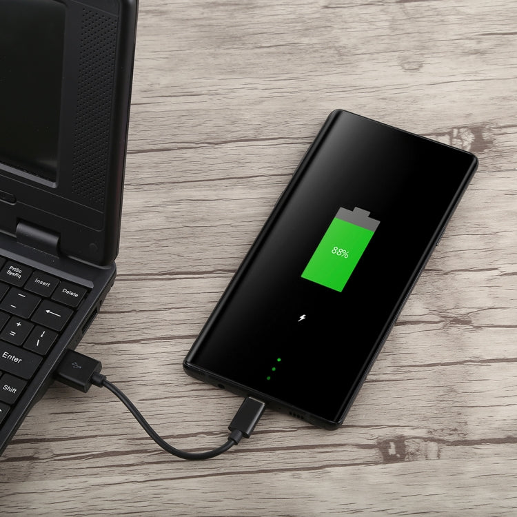 Black USB to USB-C charging cable connected to a smartphone