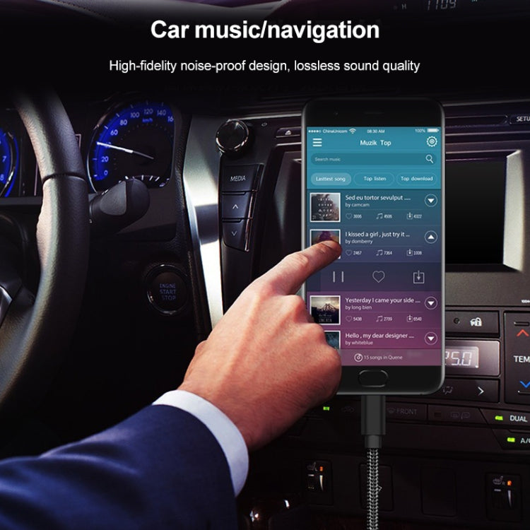 Black braided audio cable plugged into a phone for in-car audio/navigation