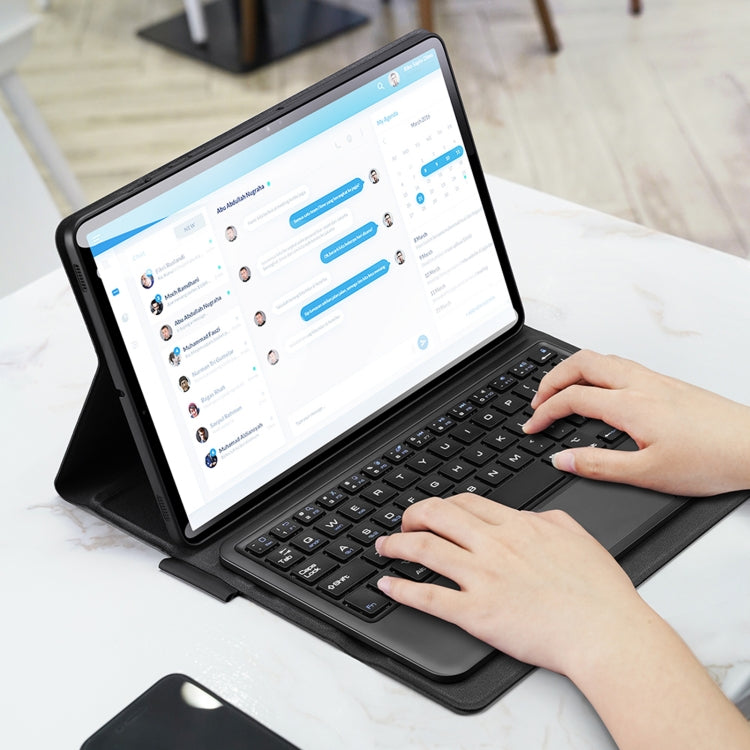 Tablet in dark gray keyboard case, hands typing on detachable Bluetooth keyboard