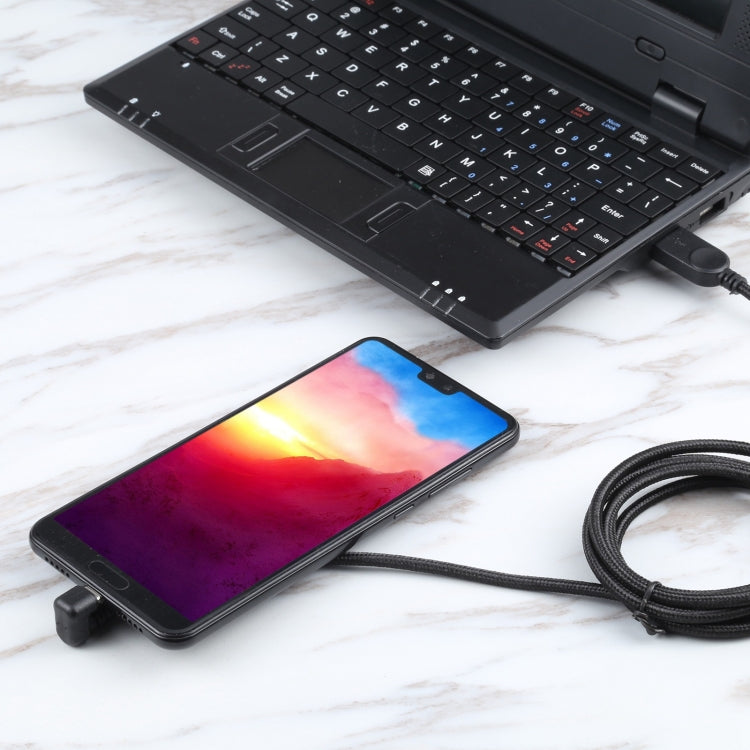 Nylon braided USB-C to USB charging cable connected to smartphone and laptop