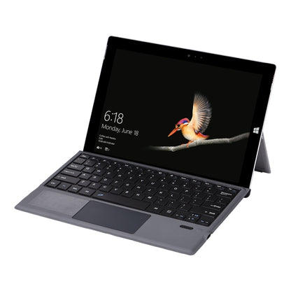 Gray foldable Bluetooth keyboard case with tablet open, showing keyboard and screen