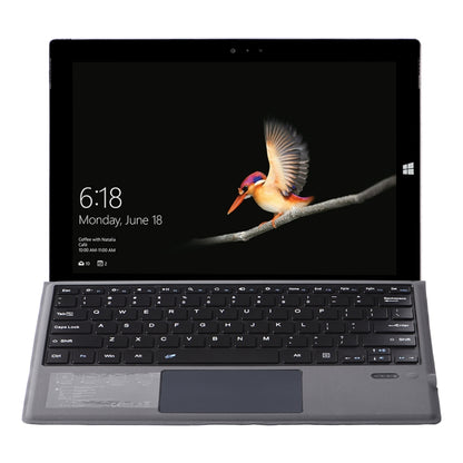 Gray tablet keyboard case, close-up of QWERTY keys and touchpad
