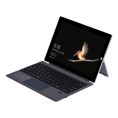 Dark Bluetooth keyboard holster case for Microsoft Surface, tablet display and stand shown
