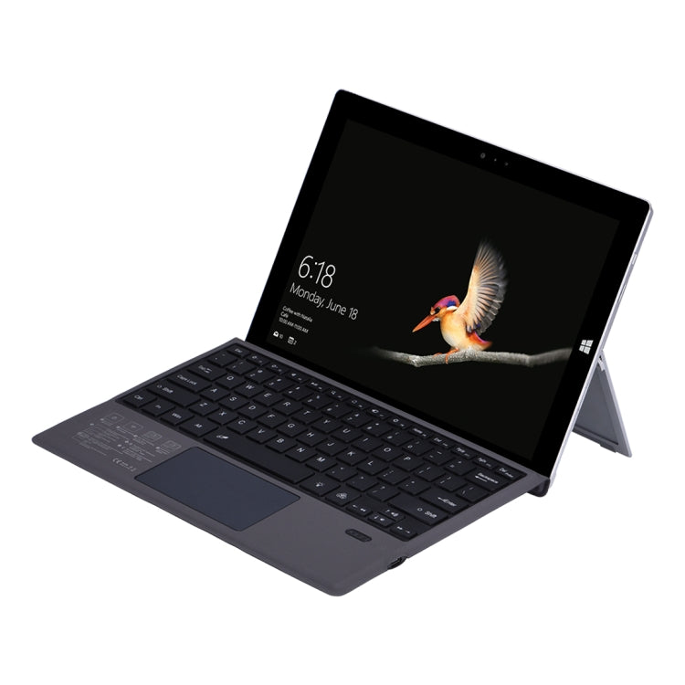 Dark Bluetooth keyboard holster case for Microsoft Surface, tablet propped on kickstand