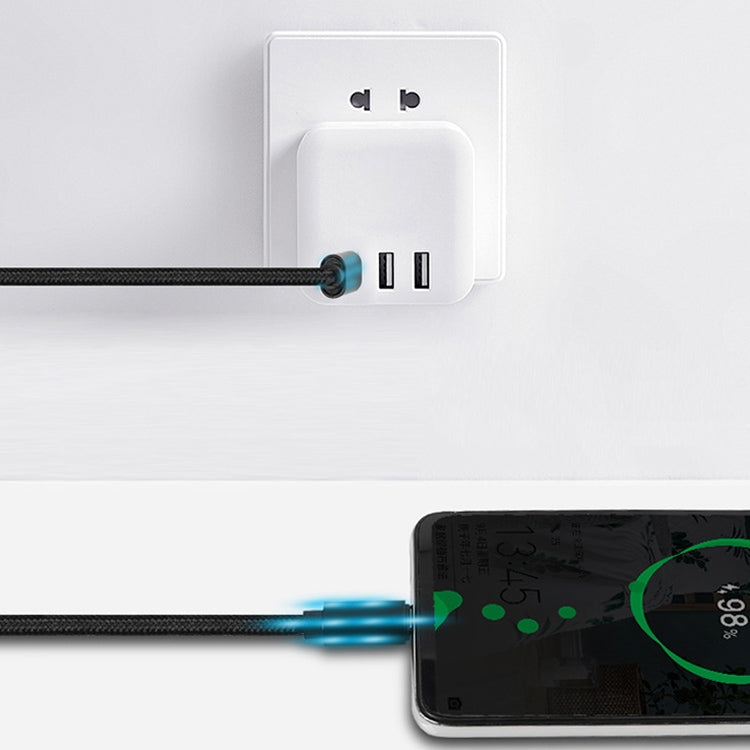 USB-C cable plugged into wall charger with ports, charging a device
