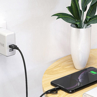 USB to Type-C and Micro USB charging cable with black connectors near smartphone