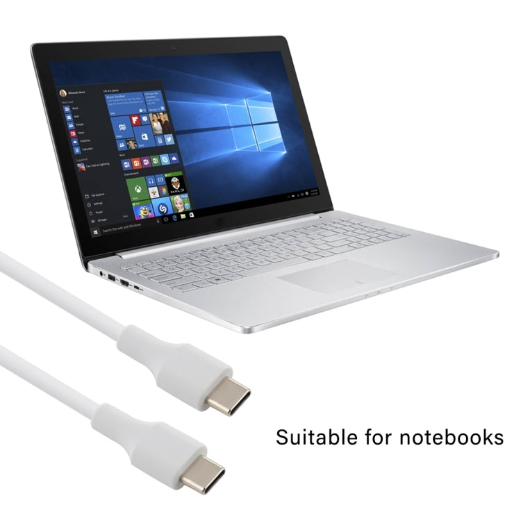 White USB-C male to male cable connected to a silver laptop