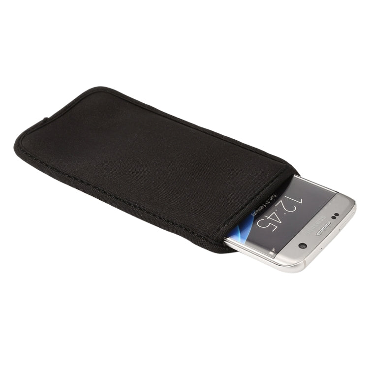 Black neoprene phone sleeve with flap open, smartphone partially inserted
