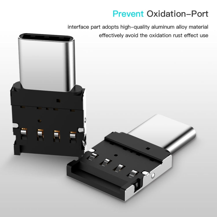 USB-C OTG adapter connector with silver housing and black port module, side view