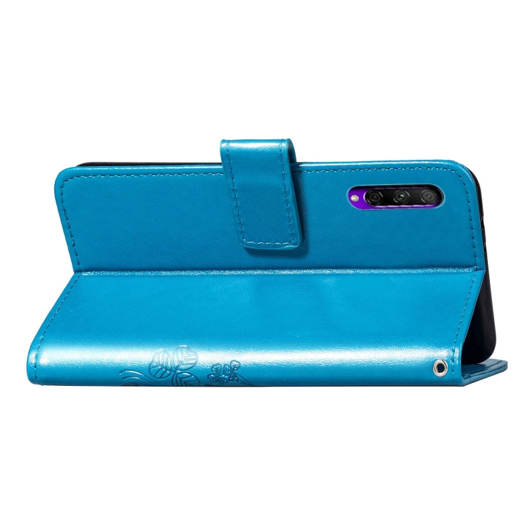 Blue leather-look phone wallet case with flap, camera opening, and strap loop.