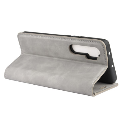 Leather magnetic wallet phone case, grey; stand view with carry strap for Xiaomi Mi Note 10 Lite.
