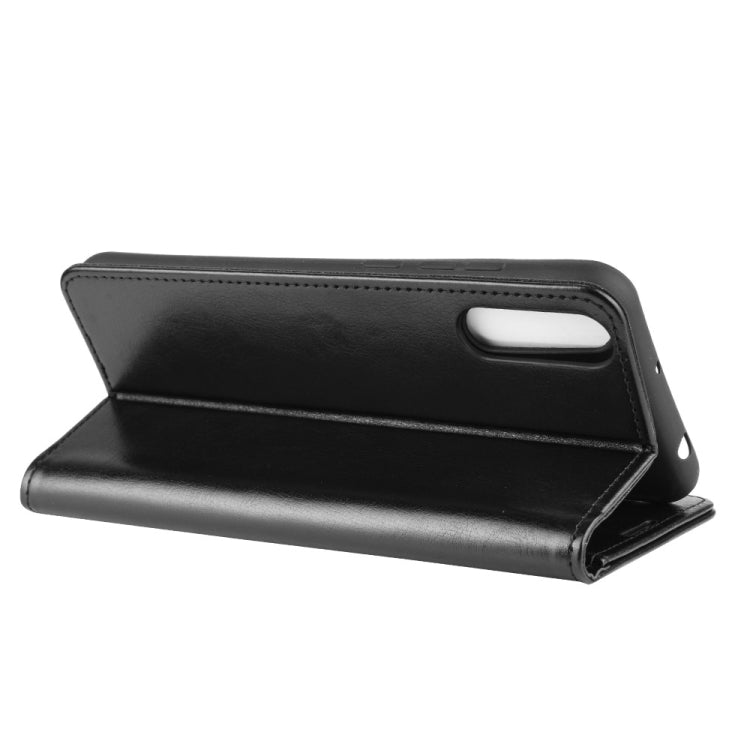 Black folio flip phone case folded open as a stand with viewing slot