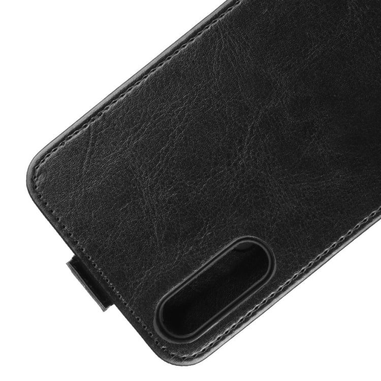Black leather flip phone case corner close-up with cutout for charging