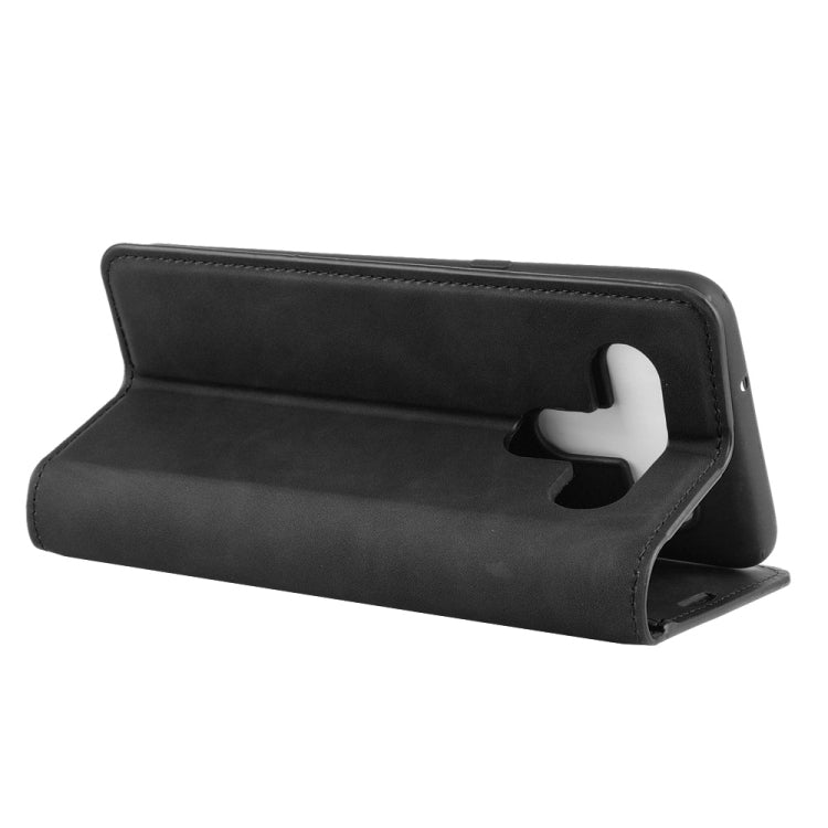 Black leather-look flip wallet case folded into a tabletop viewing stand