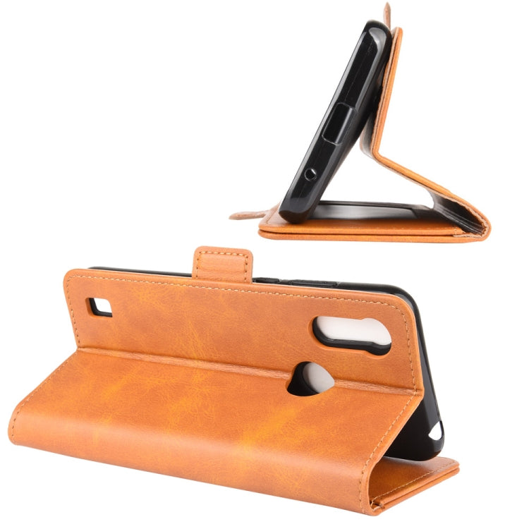 Orange leather flip phone case in stand position with cutout buttons and camera cover