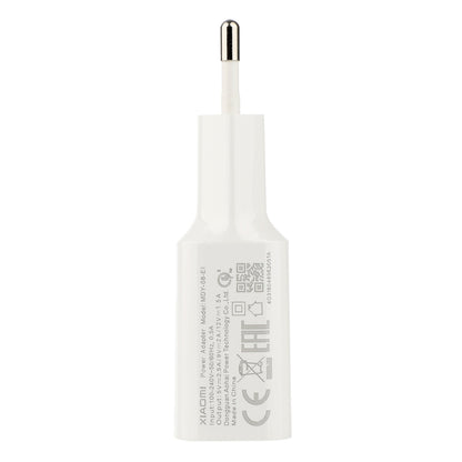 White wall charger with USB-C plug and printed compliance label on back
