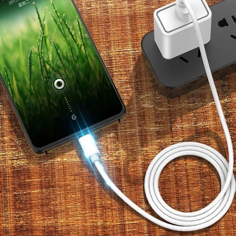 White USB-A to micro-USB charging cable plugged into a phone and power adapter
