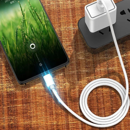 White USB-A to micro-USB charging cable plugged into a phone and power adapter