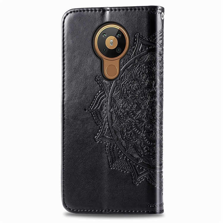 Black embossed leather-style flip case with round camera cutout and decorative mandala panel