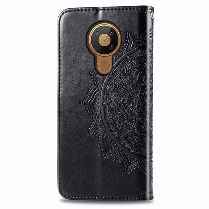 Black embossed leather-style flip case with round camera cutout and decorative mandala panel