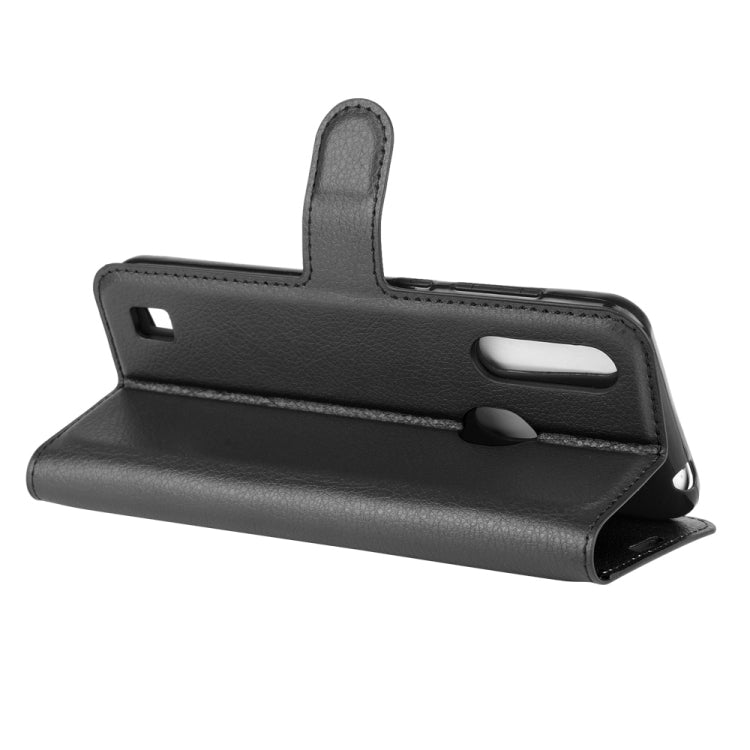 Black leather-style wallet flip phone case folded into a horizontal stand.