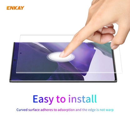 Transparent curved screen protector film being pressed onto a phone screen