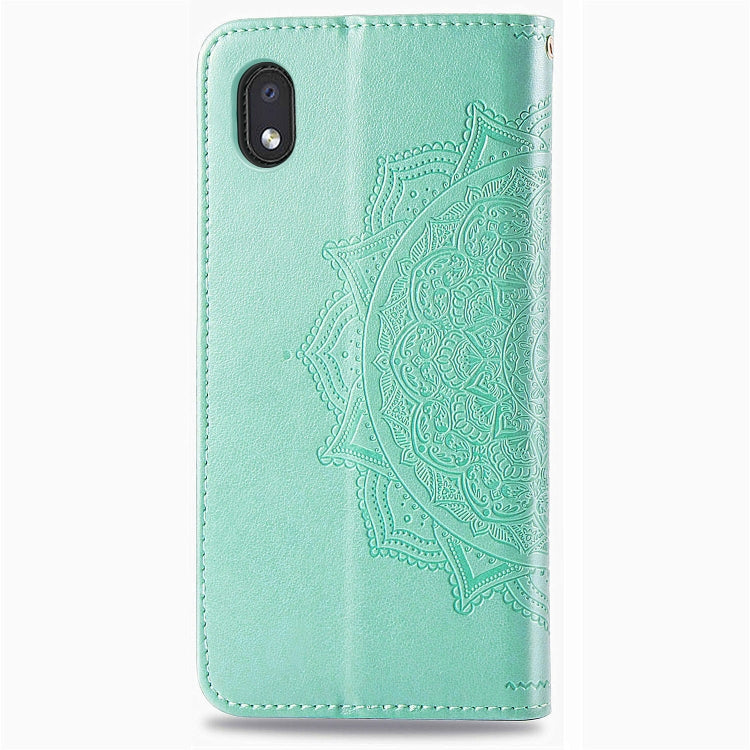 Mint green embossed leather phone case with cutouts and textured mandala flower design