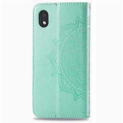 Mint green embossed leather phone case with cutouts and textured mandala flower design