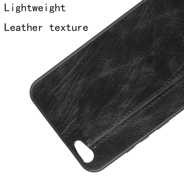 Black leather-texture phone case corner closeup with speaker cutout