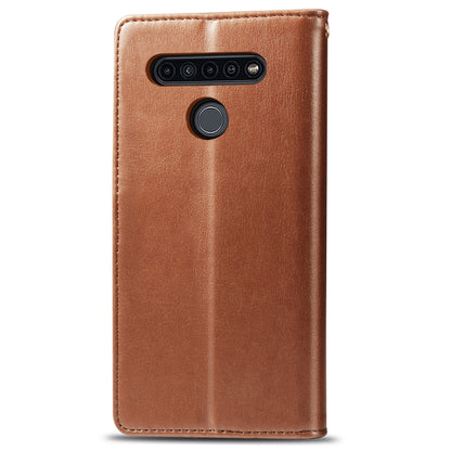 Brown leather phone case with camera cutout and circular button detail on the back