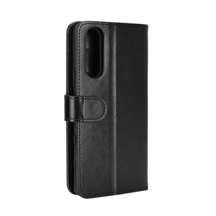 Black textured flip phone case with side strap and camera cutout