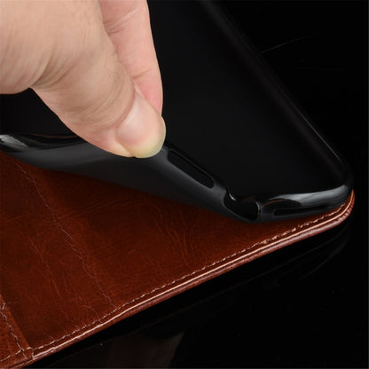 Dark brown leather-look flip case edge with hand sliding phone into slot