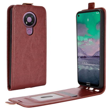 Brown leather flip phone case with camera cutout and open interior card/photo window